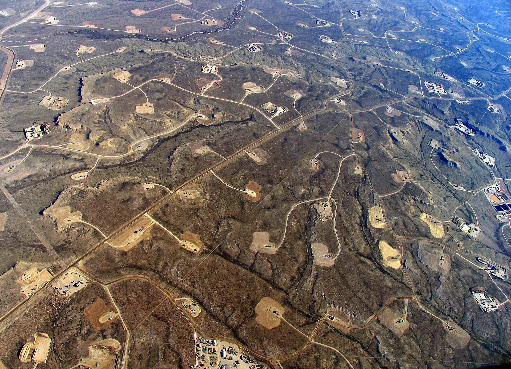 image of a dense web of roads, pipelines and oil well pads